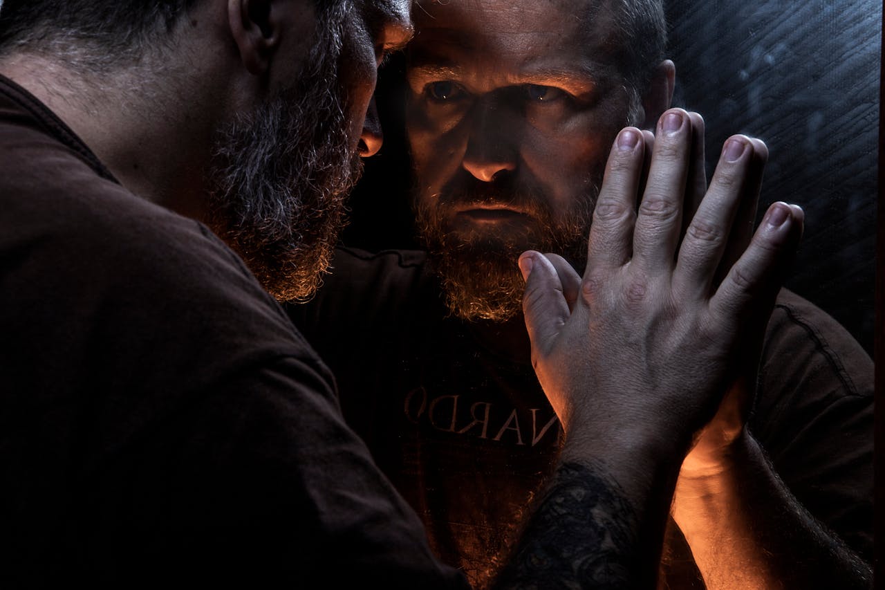 Man reflecting in a mirror during a narrative audit for clarity and pattern recognition